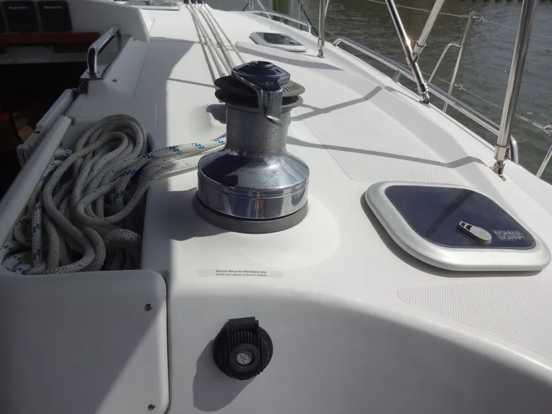 Slide: The Image of The image shows the deck of a 2009 Hunter 50 with a winch and ropes. - 17