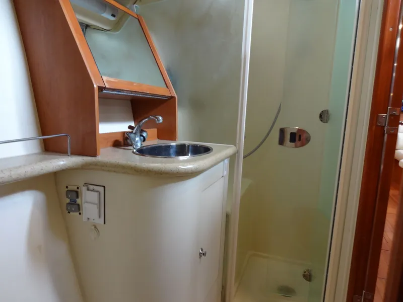 Slide: The Image of The image shows a boat bathroom with a sink and shower. - 46