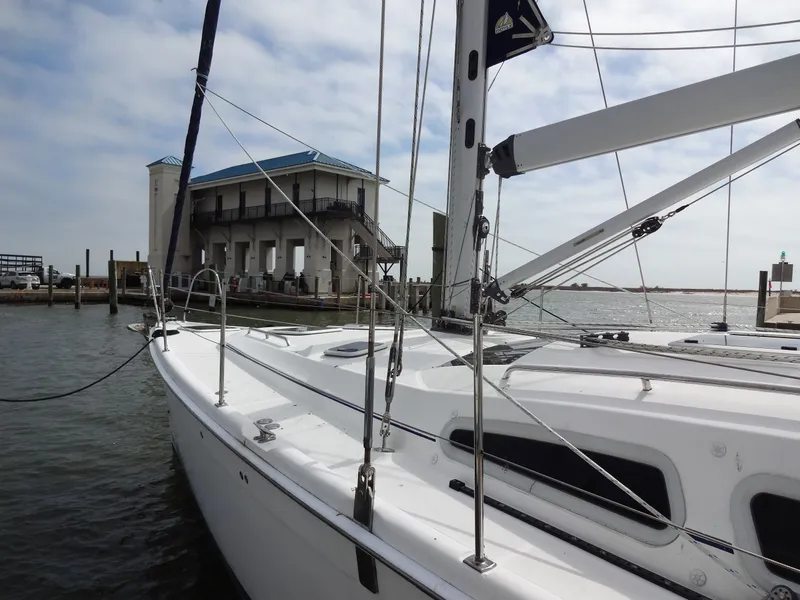 Slide: The Image of A 2009 Hunter 50 sailboat docked near a waterfront building. - 5