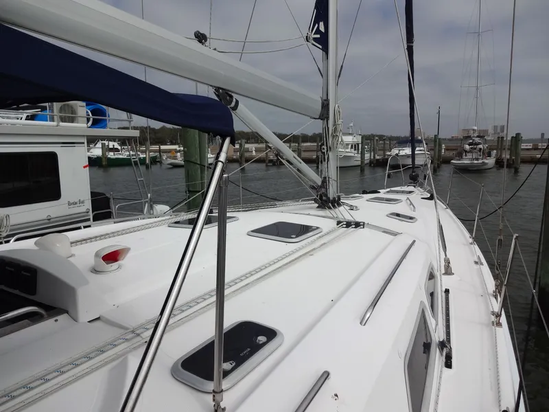 Slide: The Image of The deck of a 2009 Hunter 50 at a marina, with sails and rigging visible. - 19