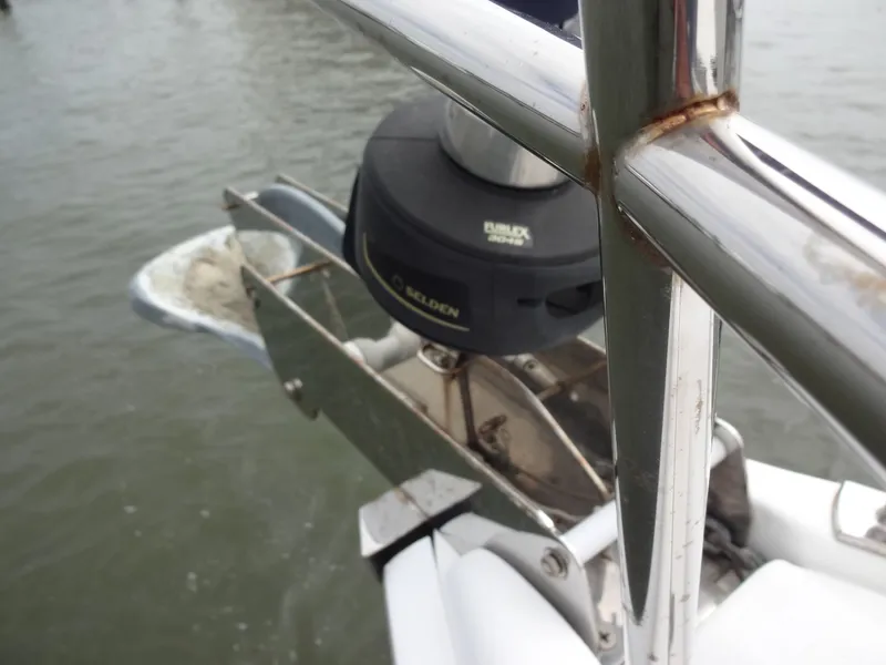 Slide: The Image of Close-up of an anchor system on a boat, featuring rusty metal parts and water in the background. - 21