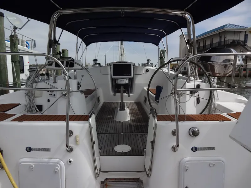 Slide: The Image of The cockpit of a 2009 Hunter 50 with dual steering wheels and a central navigation system. - 6