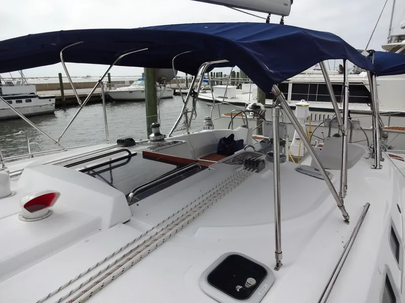 Slide: The Image of The image shows the deck of a 2009 Hunter 50 sailboat with blue sunshades. - 25