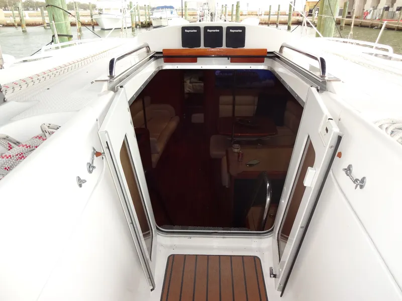 Slide: The Image of View into the interior of a 2009 Hunter 50 sailboat with wooden flooring and seating area. - 30