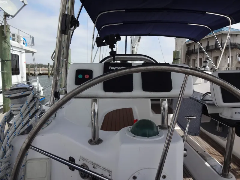 Slide: The Image of The image shows the cockpit of a 2009 Hunter 50 with a steering wheel and navigation instruments. - 12