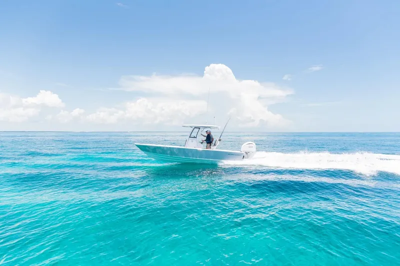 Slide: The Image of 2026 Sportsman Masters 247 Bay Boat cruising on clear blue ocean waters. - 1