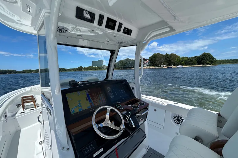 Slide: The Image of Interior view of 2027 Everglades 315 Center Console boat on a scenic lake. - 24