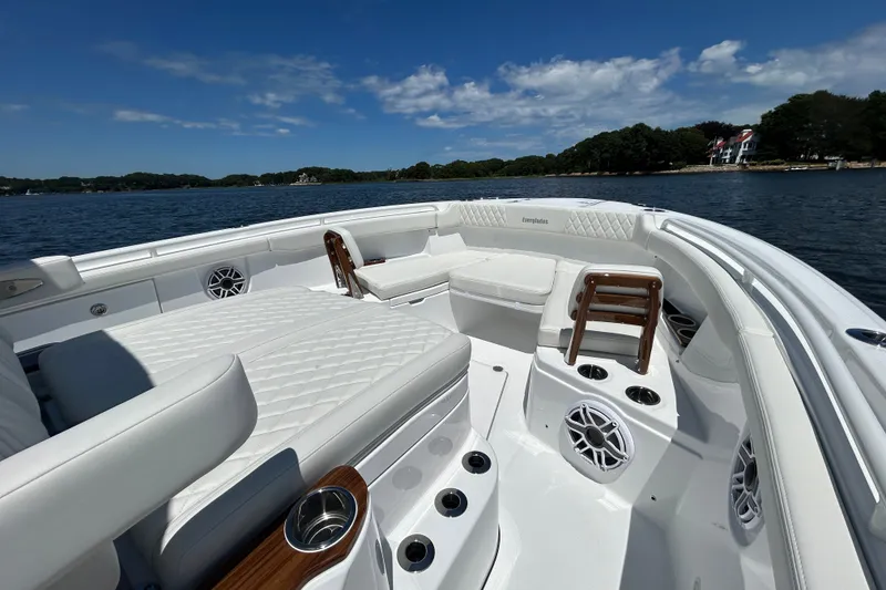 Slide: The Image of 2027 Everglades 315 Center Console boat with luxurious seating on a serene lake. - 36