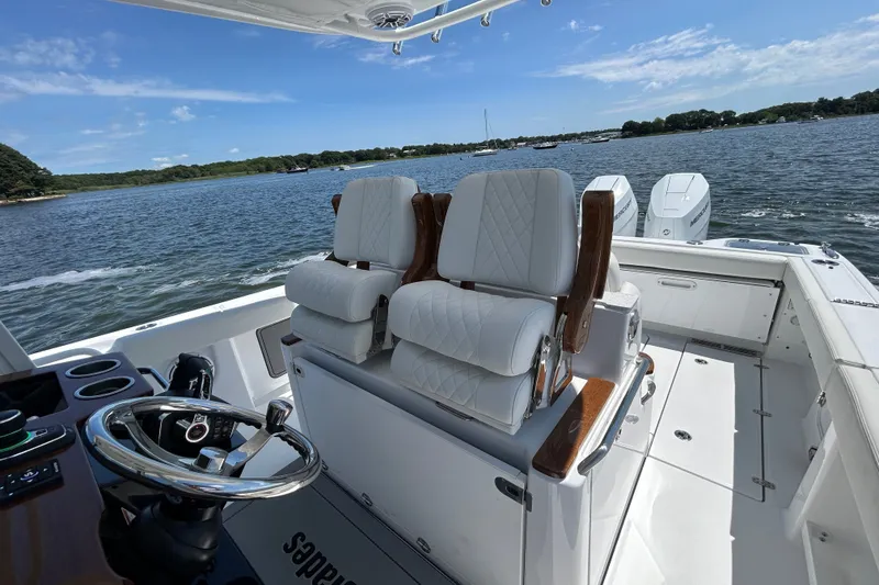 Slide: The Image of 2027 Everglades 315 Center Console boat interior with luxurious seating and scenic water view. - 27