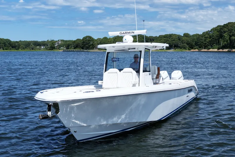 Slide: The Image of 2027 Everglades 315 Center Console boat on calm water, featuring sleek design and advanced navigation. - 12