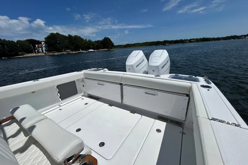 Slide: The Image of 2027 Everglades 315 Center Console boat on water, featuring dual Mercury engines. - 19