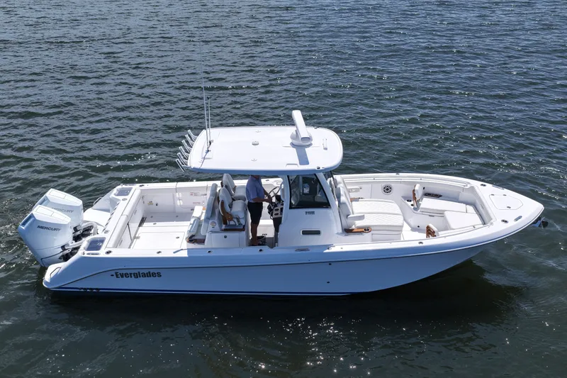 Slide: The Image of 2027 Everglades 315 Center Console boat on open water, side view. - 13