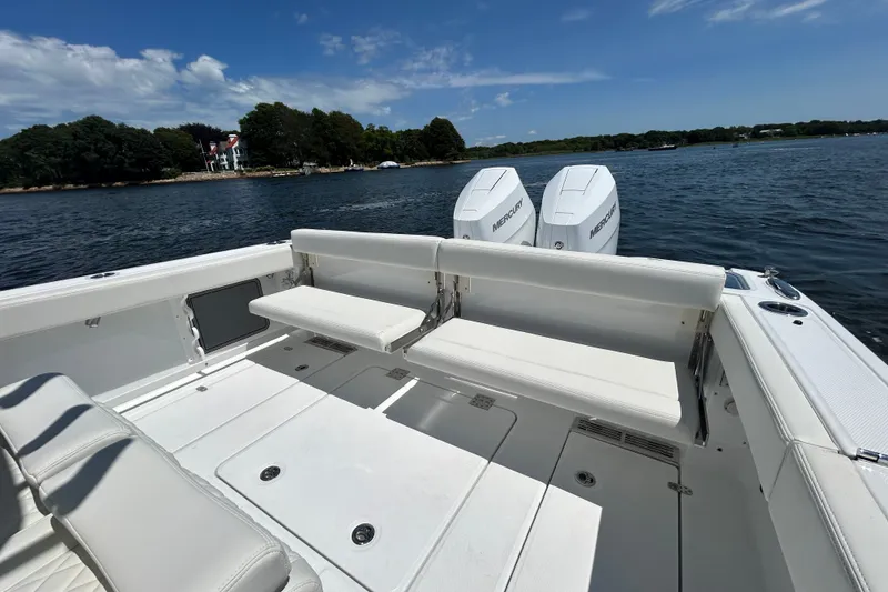 Slide: The Image of 2027 Everglades 315 Center Console boat with dual Mercury engines on a scenic lake. - 20