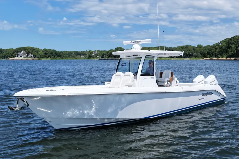 Slide: The Image of 2027 Everglades 315 Center Console boat on calm water under a partly cloudy sky. - 11