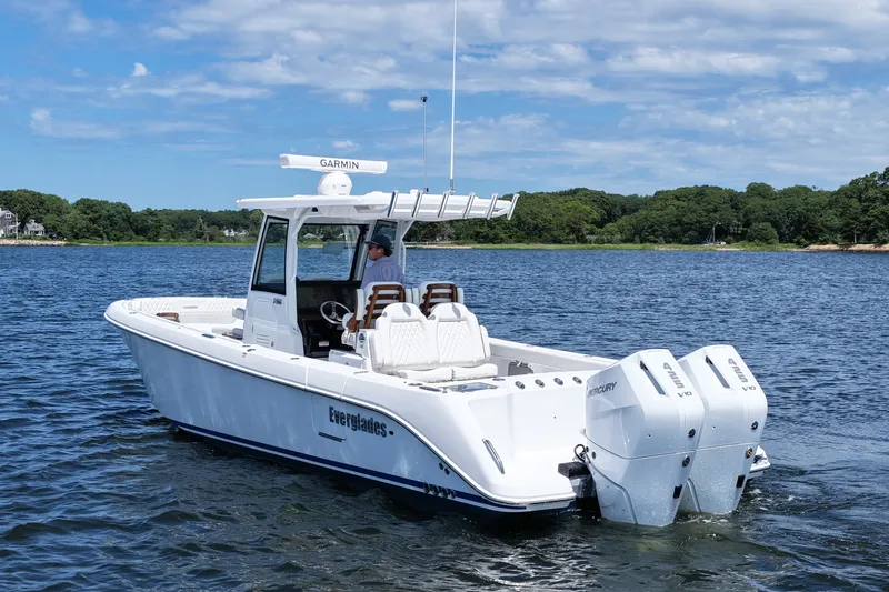 Slide: The Image of 2027 Everglades 315 Center Console boat on water with twin Mercury engines. - 8
