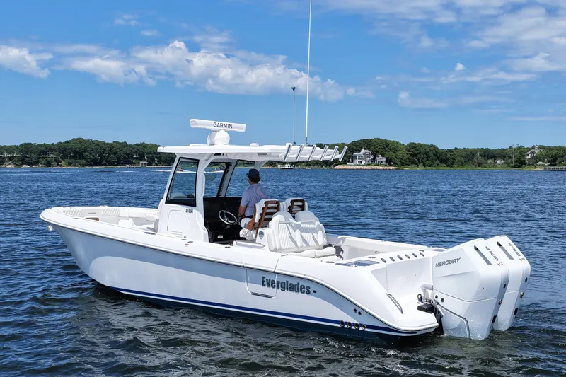 Slide: The Image of 2027 Everglades 315 Center Console boat on water, featuring dual Mercury engines. - 9