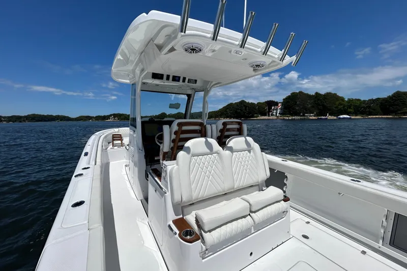 Slide: The Image of 2027 Everglades 315 Center Console boat on water, featuring luxurious seating and sleek design. - 21