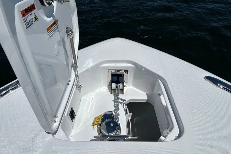 Slide: The Image of 2027 Everglades 315 Center Console anchor compartment with open hatch on calm water. - 38