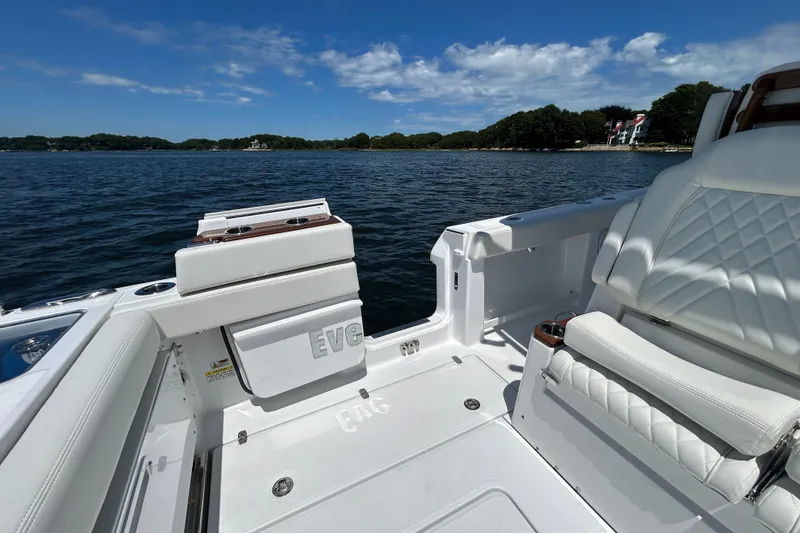Slide: The Image of 2027 Everglades 315 Center Console boat interior with white seating, on a sunny day. - 32