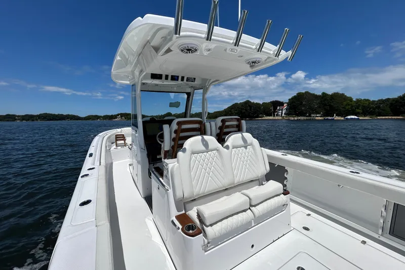 Slide: The Image of 2027 Everglades 315 Center Console boat on water, featuring sleek design and comfortable seating. - 22