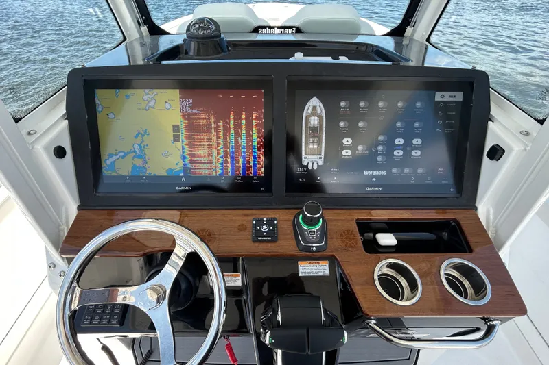 Slide: The Image of 2027 Everglades 315 Center Console dashboard with dual Garmin displays and modern controls. - 25