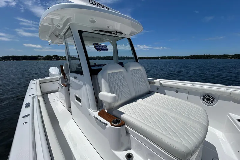 Slide: The Image of 2027 Everglades 315 Center Console boat on water, featuring luxurious seating and advanced navigation. - 39