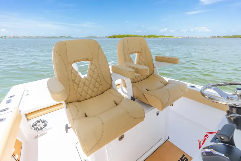 Slide: The Image of Luxurious seating on 2026 Sportsman Masters 267 Bay Boat, overlooking serene waters. - 15