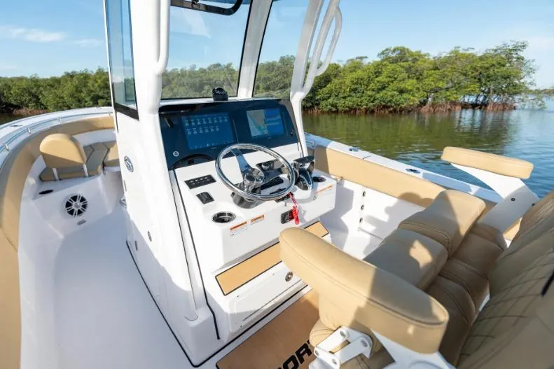 Slide: The Image of 2026 Sportsman Masters 247OE Bay Boat interior with modern dashboard and seating. - 2