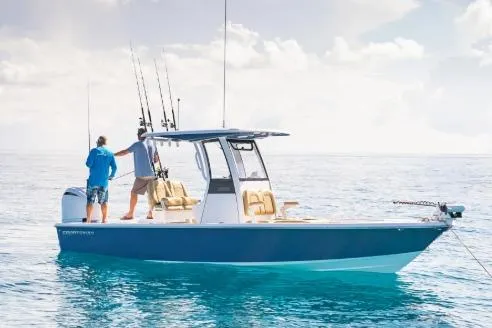Slide: The Image of 2026 Sportsman Masters 247OE Bay Boat on calm ocean waters, two people fishing. - 1