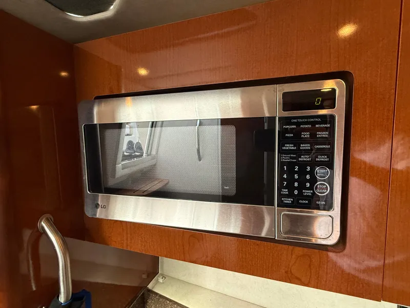 Slide: The Image of A built-in LG microwave in a wooden cabinet, with a window in the background. - 35
