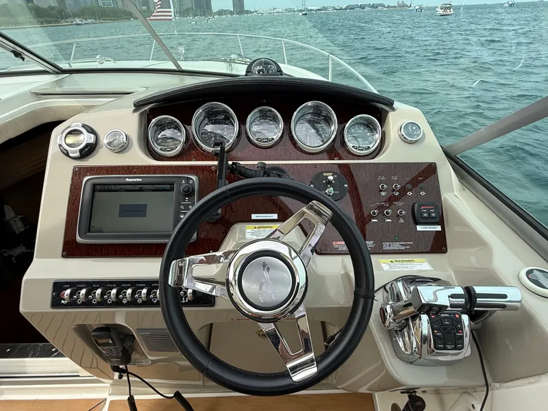 Slide: The Image of The cockpit of a 2013 Sea Ray 370 Venture with a sleek dashboard and controls. - 19