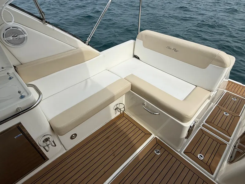 Slide: The Image of The image shows the cockpit of a 2013 Sea Ray 370 Venture with beige upholstery and wood flooring. - 15