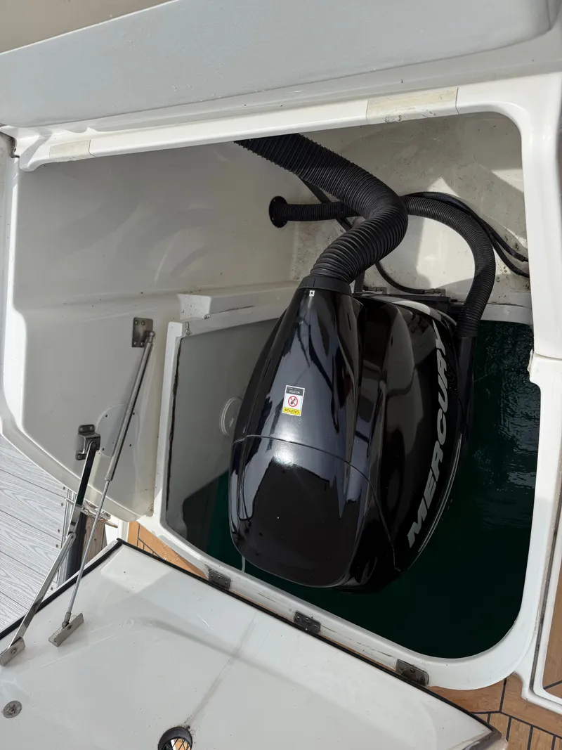 Slide: The Image of A Mercury outboard motor housed in a compartment of a 2013 Sea Ray 370 Venture. - 27