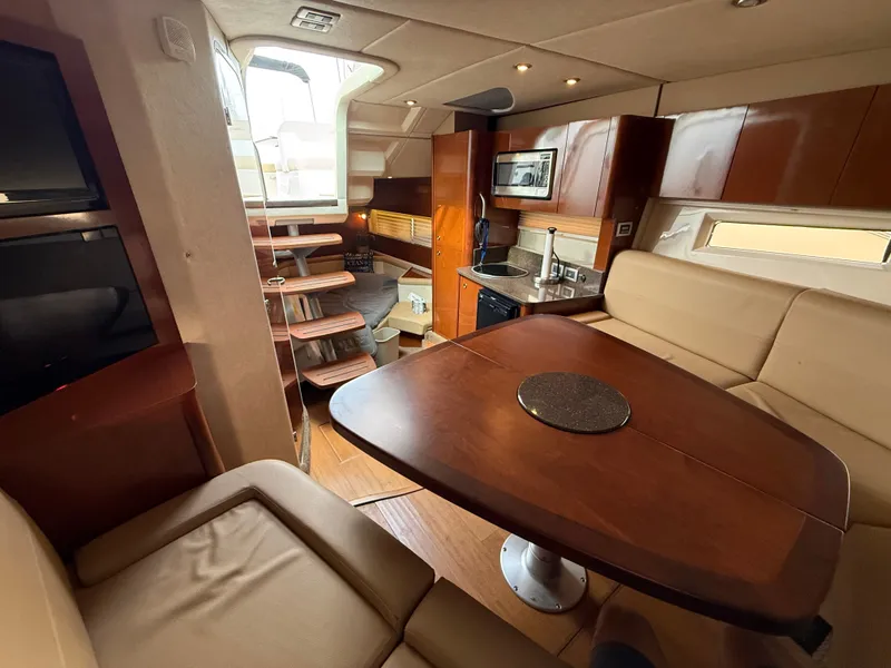 Slide: The Image of Interior of a 2013 Sea Ray 370 Venture with elegant wood finishes and a cozy seating area. - 31