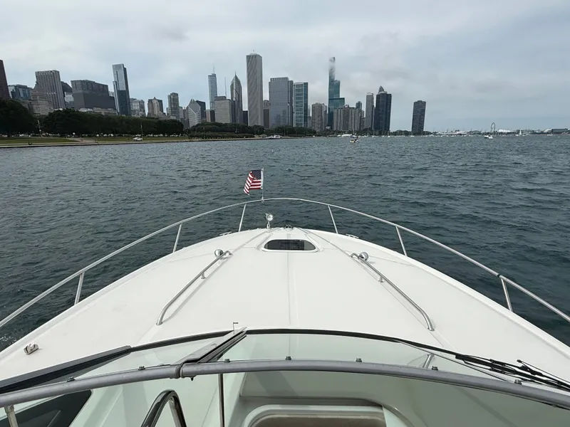 Slide: The Image of A 2013 Sea Ray 370 Venture on the water with a city skyline in the background. - 22