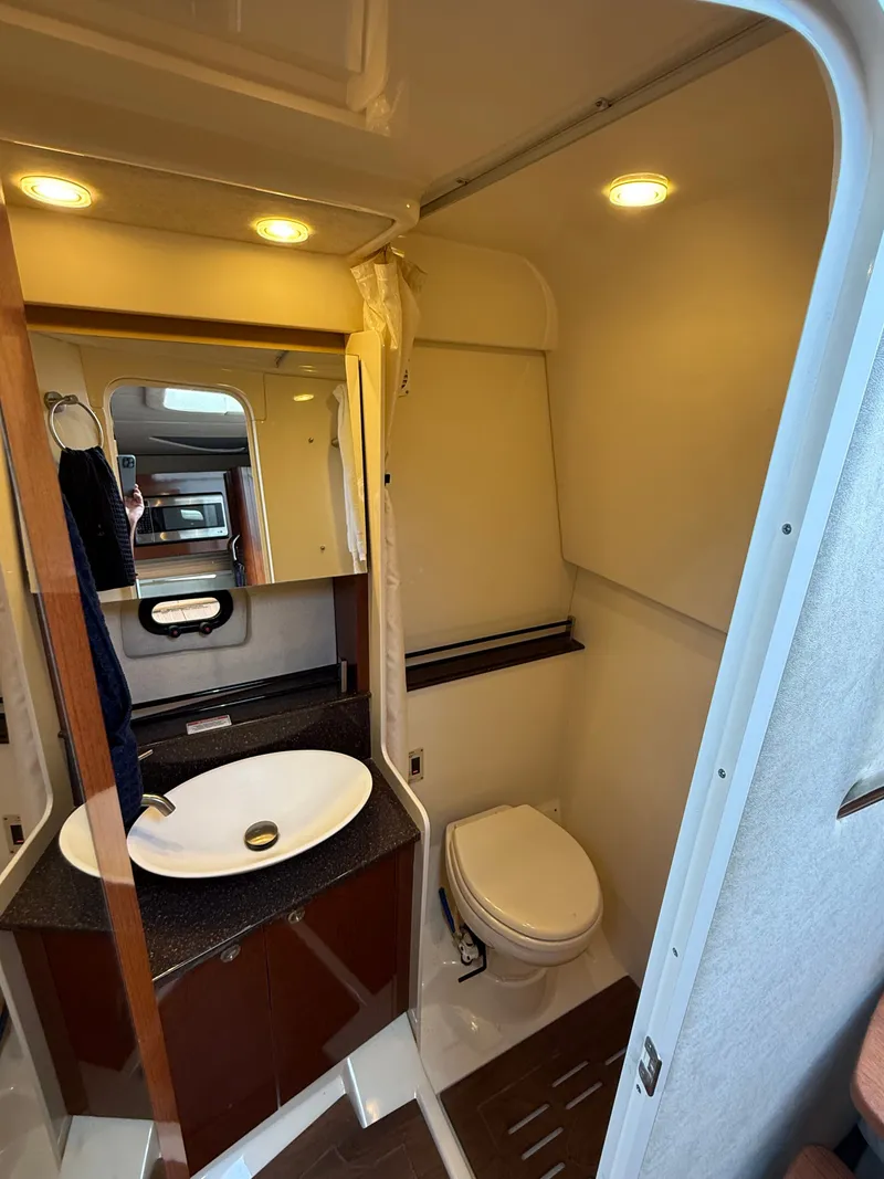 Slide: The Image of The image shows a boat bathroom with a sink, toilet, and mirror. - 44