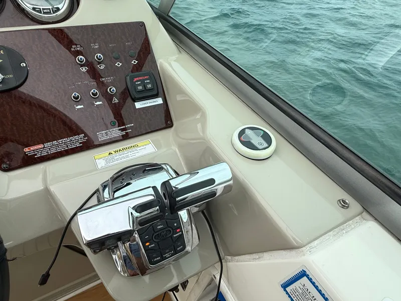 Slide: The Image of The image shows the helm of a 2013 Sea Ray 370 Venture with controls and a view of the water. - 21