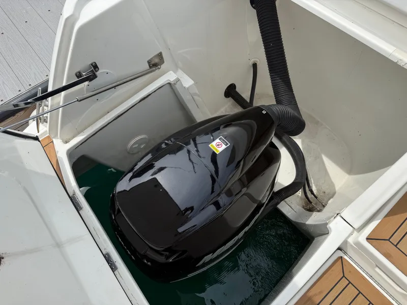 Slide: The Image of A black engine in a boat compartment, surrounded by white surfaces and wood details. - 26