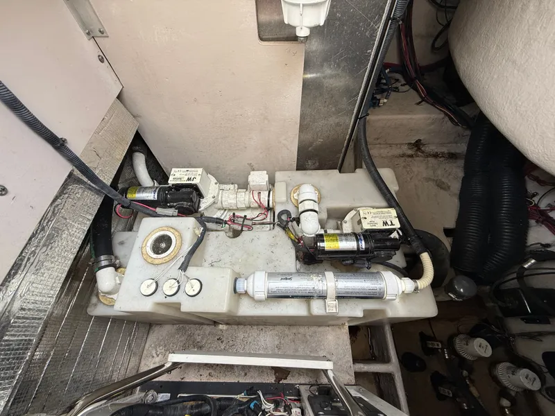 Slide: The Image of View of the engine room in a 2013 Sea Ray 370 Venture with pumps and piping. - 46