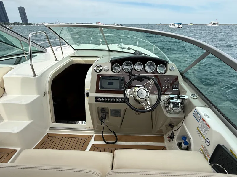 Slide: The Image of The image shows the cockpit of a 2013 Sea Ray 370 Venture with a modern helm. - 18