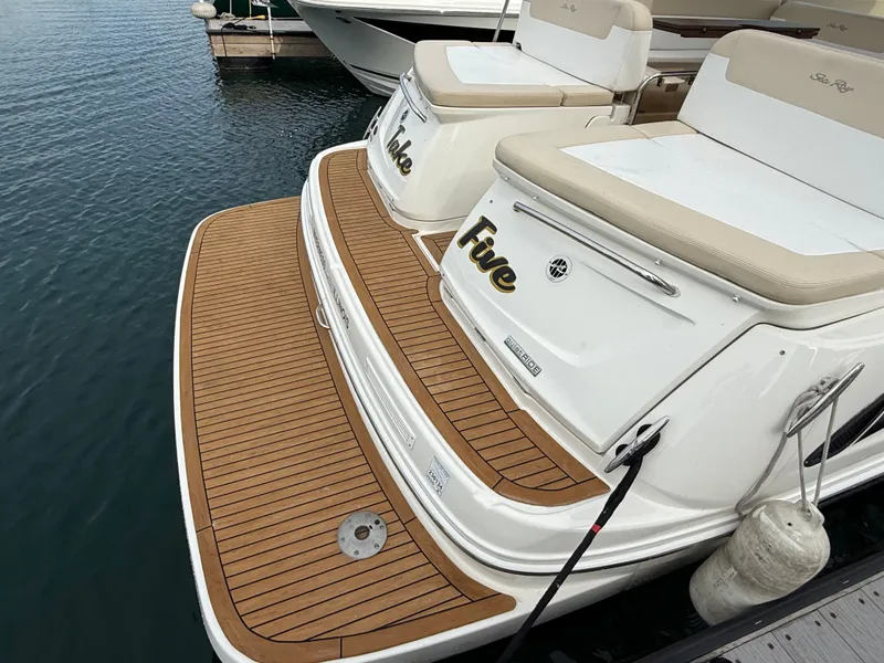 Slide: The Image of The image shows the stern of a 2013 Sea Ray 370 Venture with a teak deck. - 24