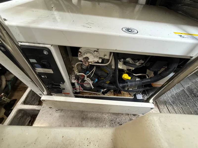 Slide: The Image of A technical area of a boat with wires and switches, likely a generator or machinery. - 48