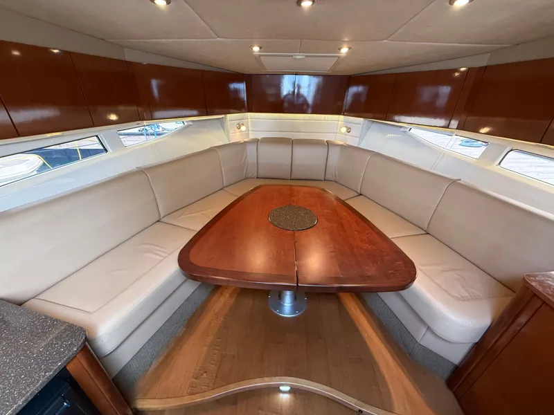 Slide: The Image of Interior of the 2013 Sea Ray 370 Venture with elegant seating area and wooden table. - 37