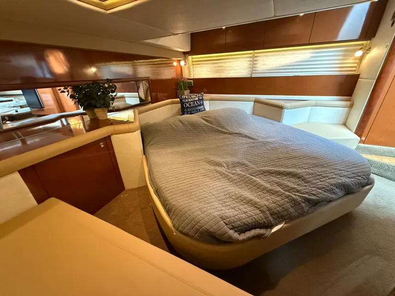 Slide: The Image of Interior of the 2013 Sea Ray 370 Venture with a cozy bed and elegant wood accents. - 40