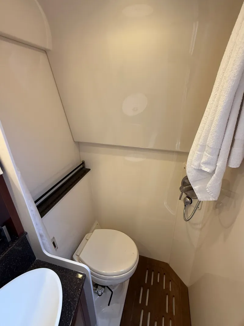 Slide: The Image of The image shows a boat bathroom with a toilet, sink, and towels. - 45