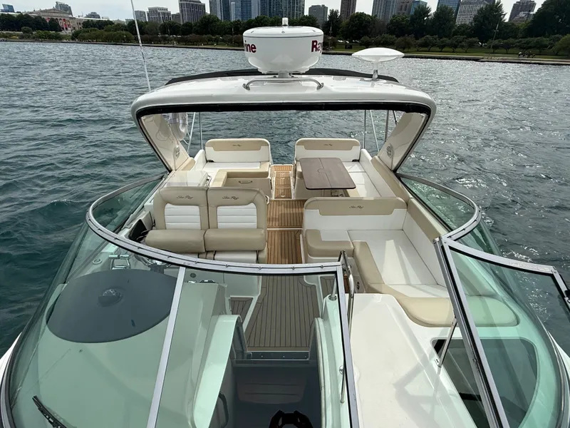 Slide: The Image of The image shows the deck of a 2013 Sea Ray 370 Venture with elegant seating and a table. - 12