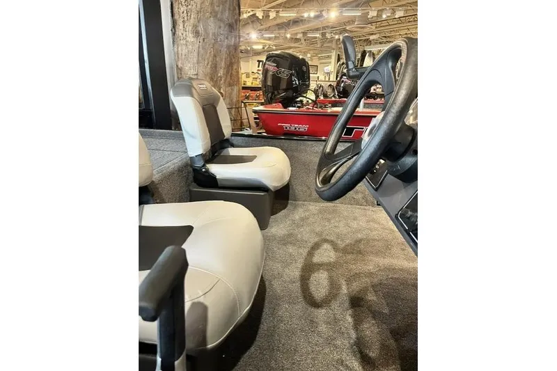Slide: The Image of Interior view of 2027 Tracker Bass Tracker Classic XL boat with seating and steering wheel. - 6