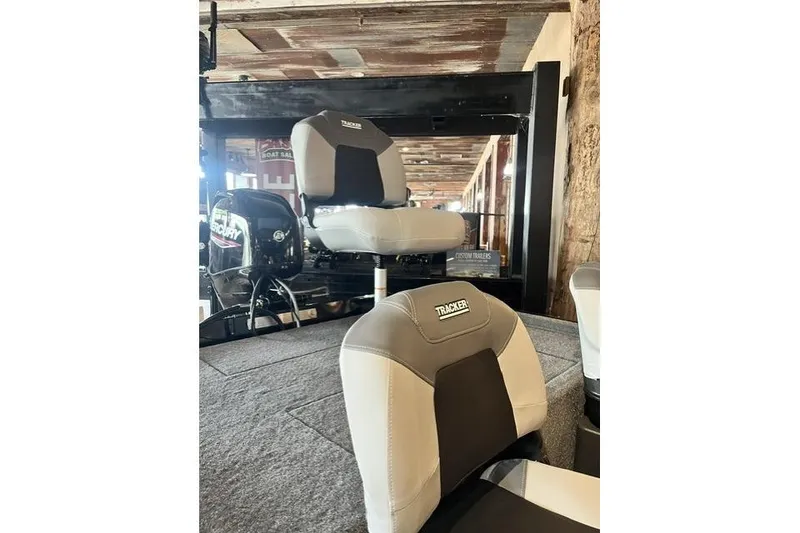 Slide: The Image of 2027 Tracker Bass Tracker Classic XL boat seats and Mercury engine in showroom. - 8