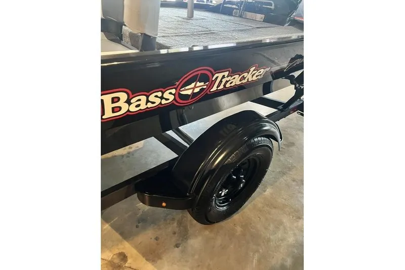 Slide: The Image of 2027 Tracker Bass Tracker Classic XL trailer with logo, black wheel, and fender. - 3