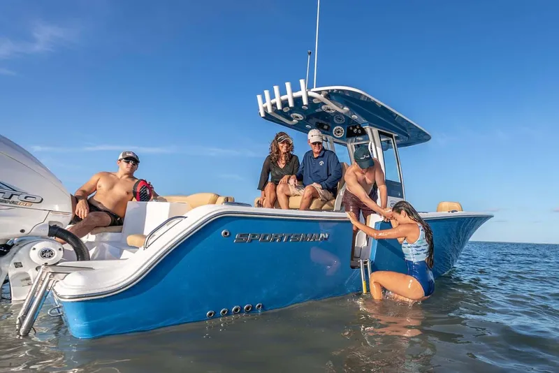 Slide: The Image of Manufacturer Provided Image: 2025 Sportsman Heritage 261 Center Console with people enjoying a sunny day on the water. - 5